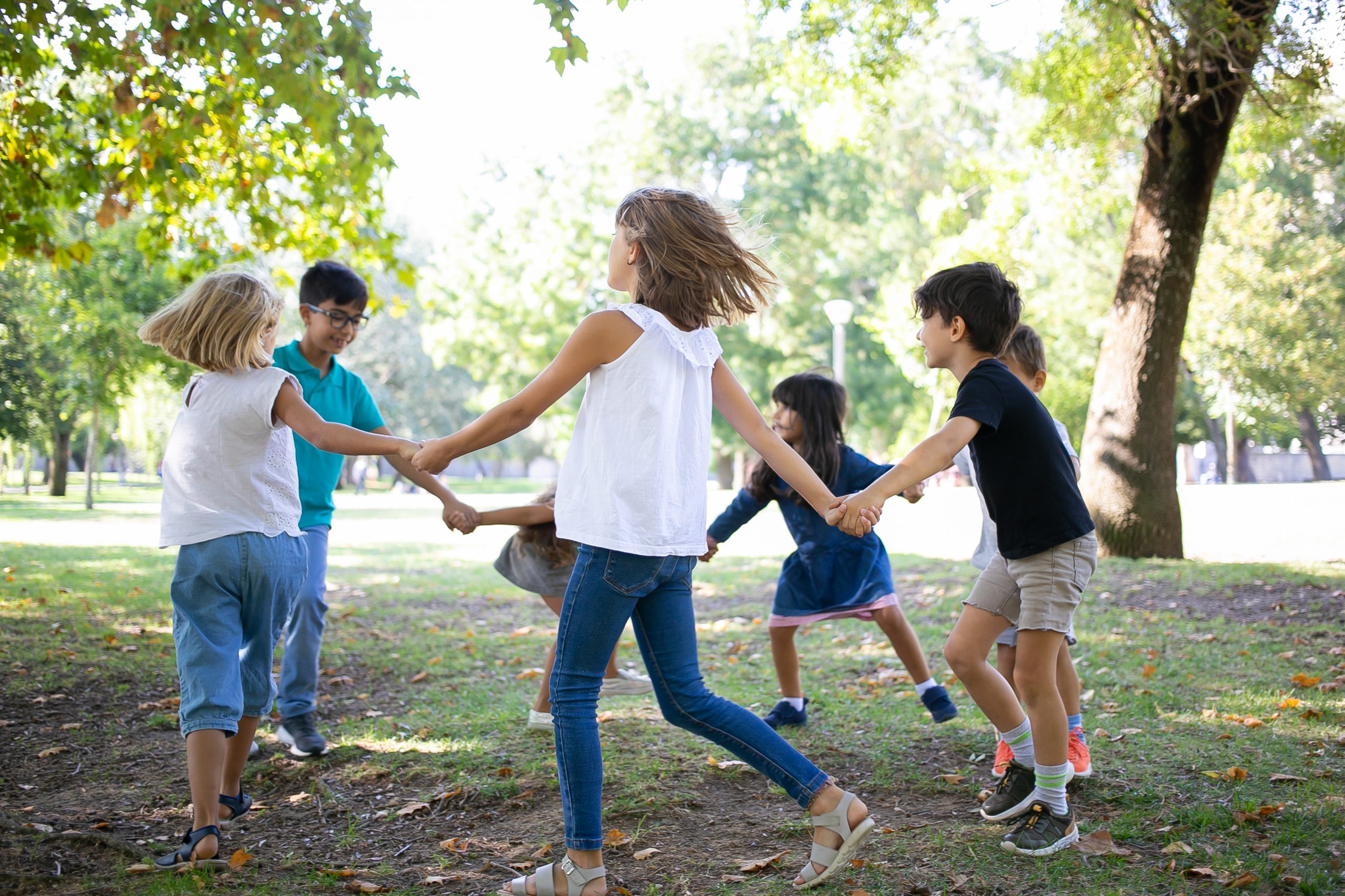 group children holding hands dancing around enjoying outdoor activities having fun park kids party friendship concept scaled - Mütterzentrum e.V. Leipzig